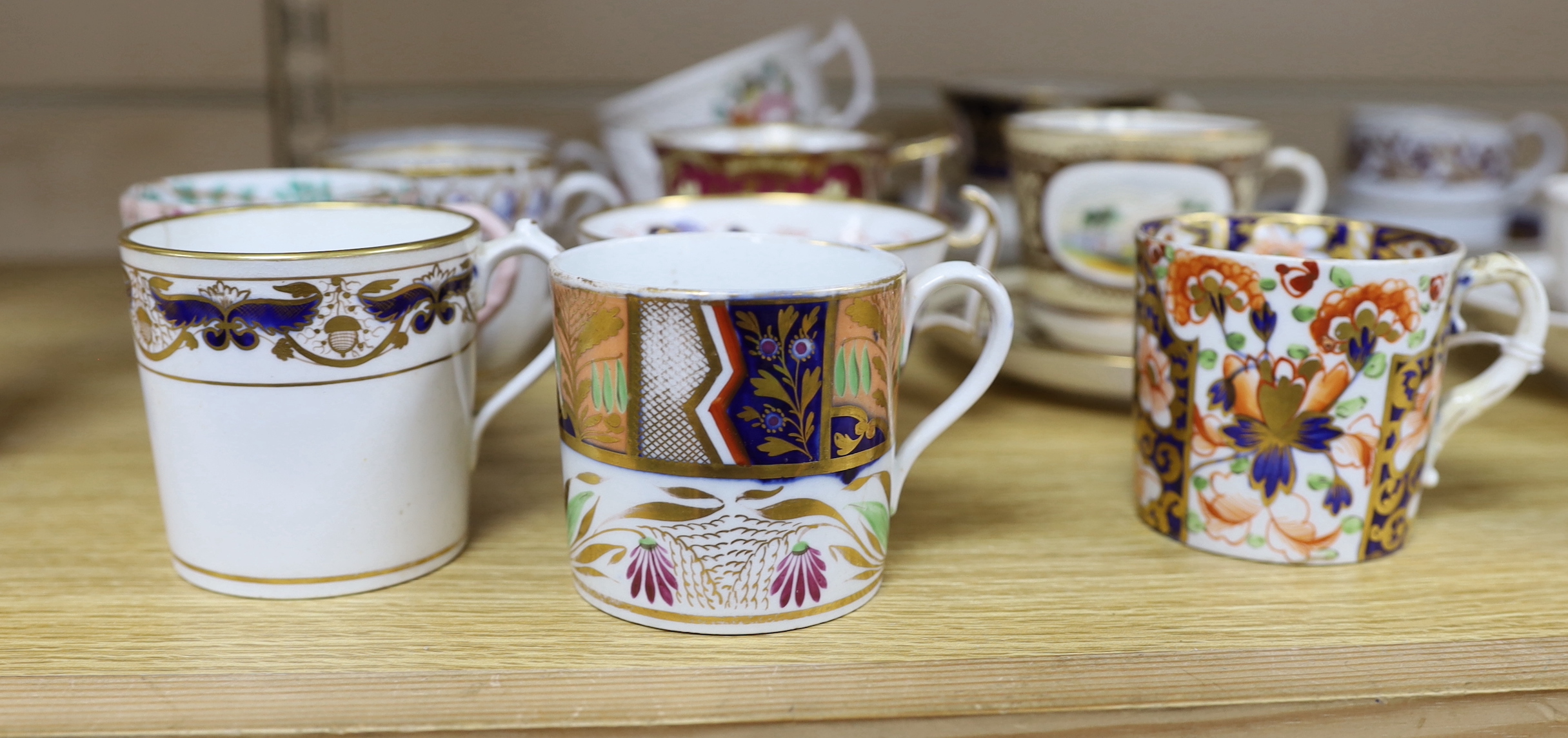 A collection of 18th and 19th century English and continental tea and coffee cups some with saucers, including a Worcester Queen Charlotte pattern coffee cup and saucer